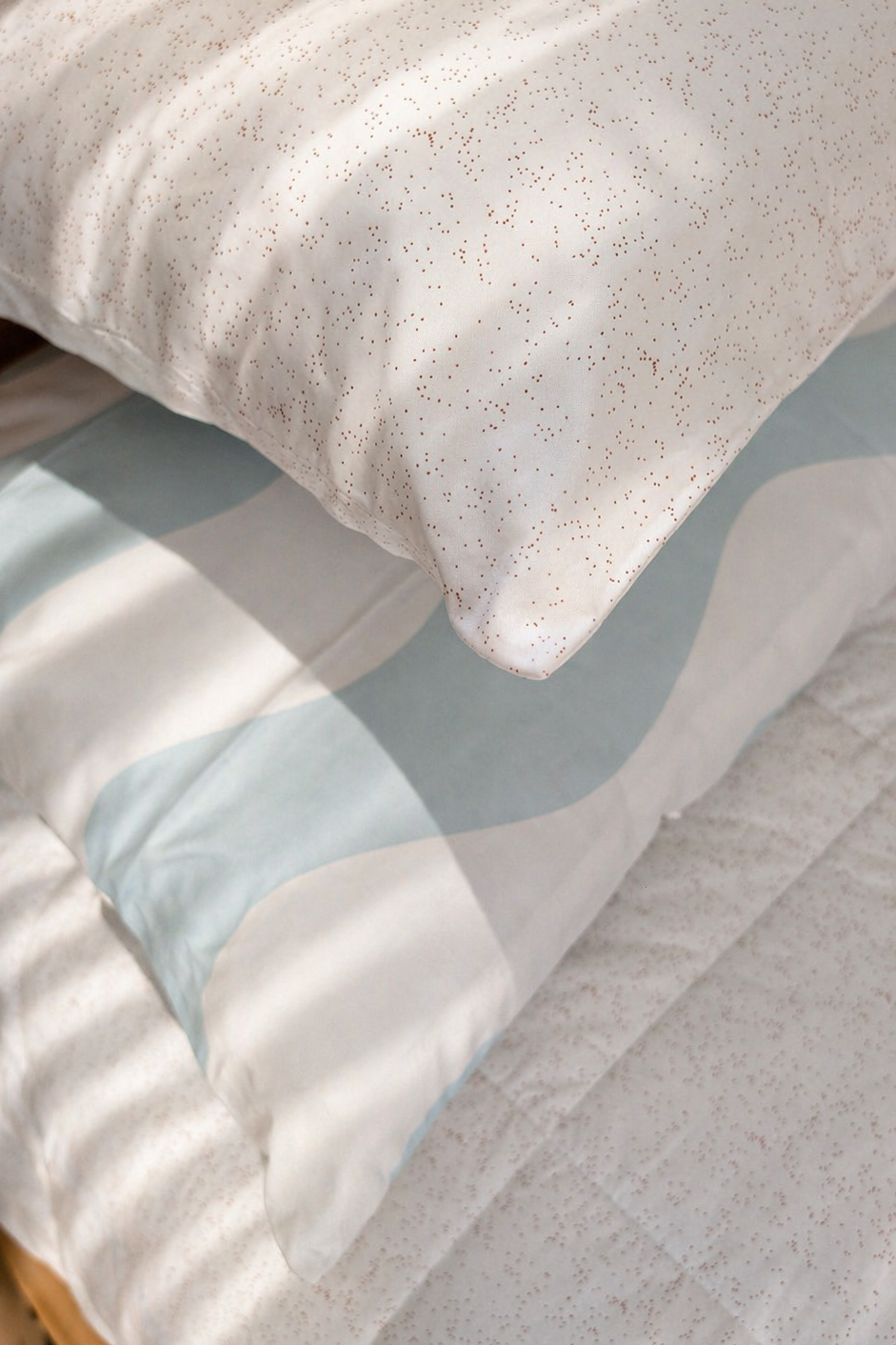 Baby blue waves and speckle pillowcases paired as a kids bedding set