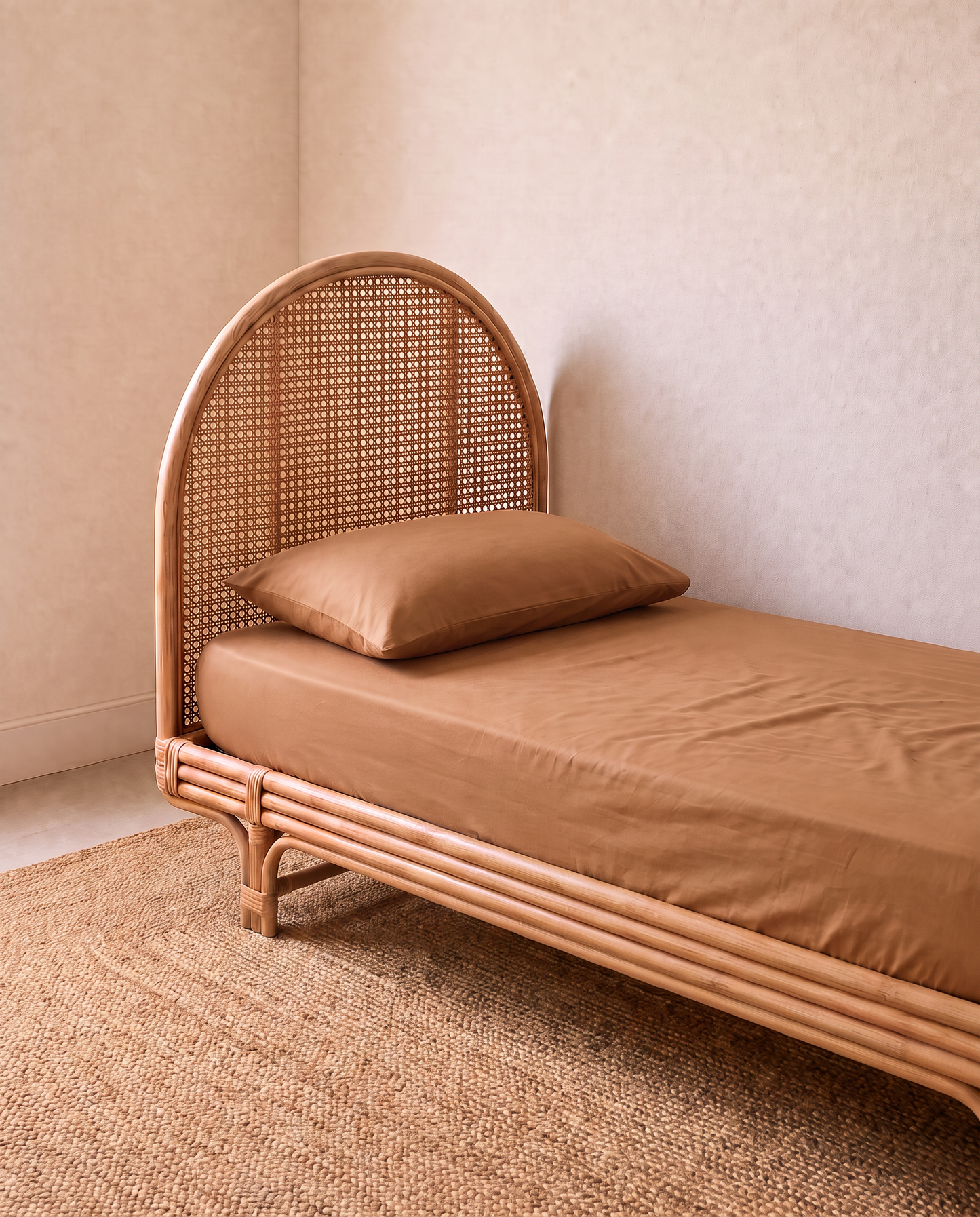 single bed with light brown fitted sheet by the cuddle collective