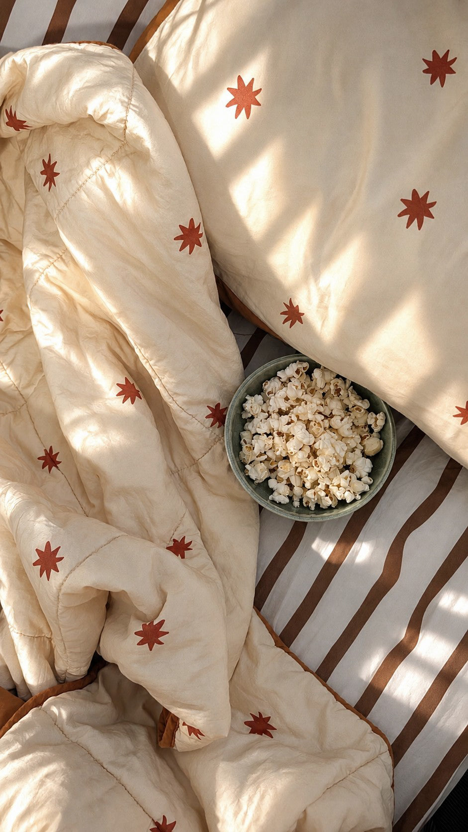 the cuddle collective reversible quilt featuring a teracorra star pattern and stripe kids sheet set