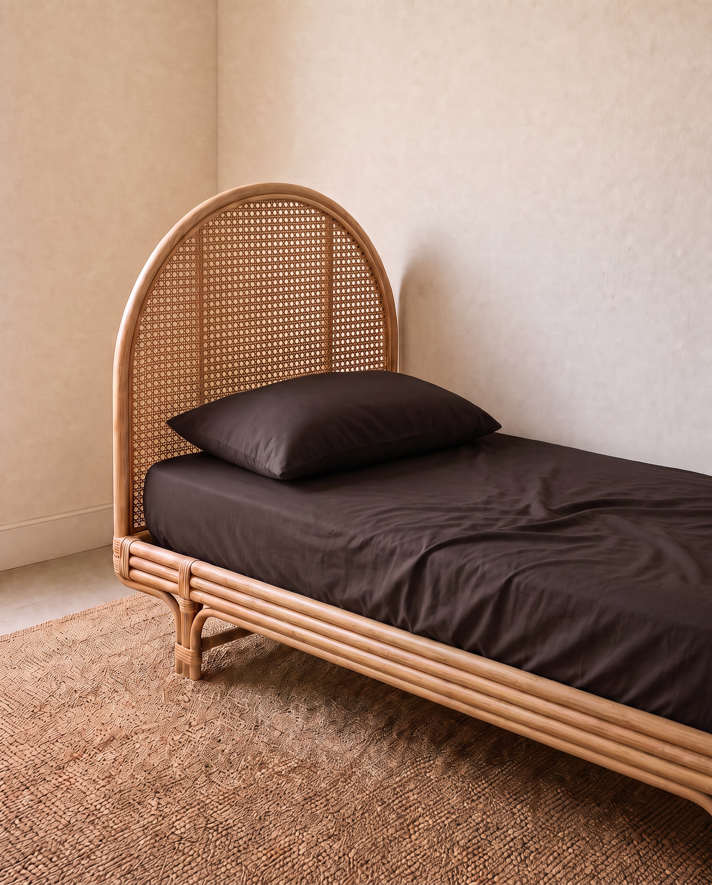 a kids single bed with dark brown sheet set