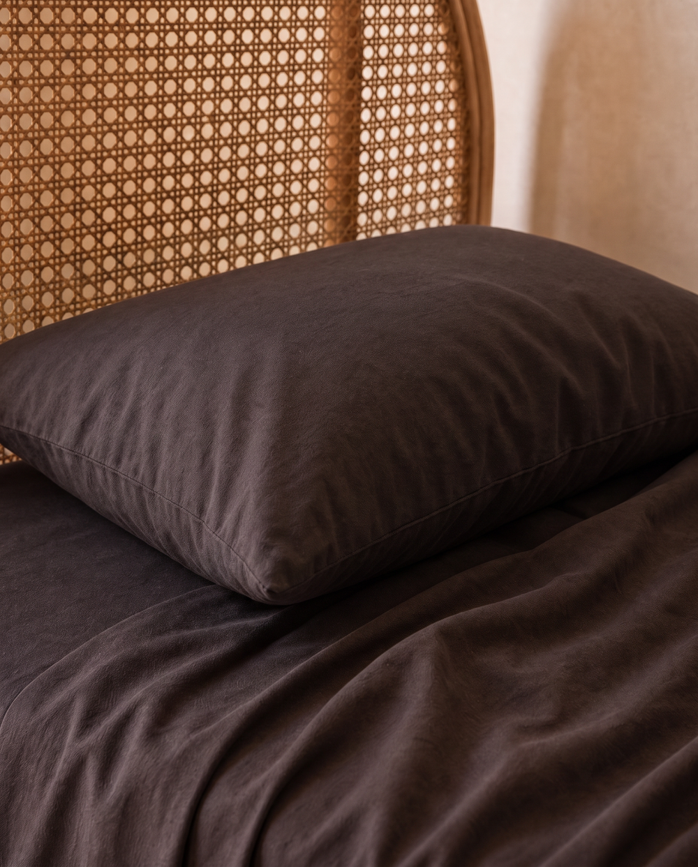 Dark brown cotton bedding set with a matching pillowcase, styled on a kids single bed