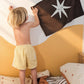 A star on a brown canvas wall banner made of 100% cotton as decor in a kids bedroom