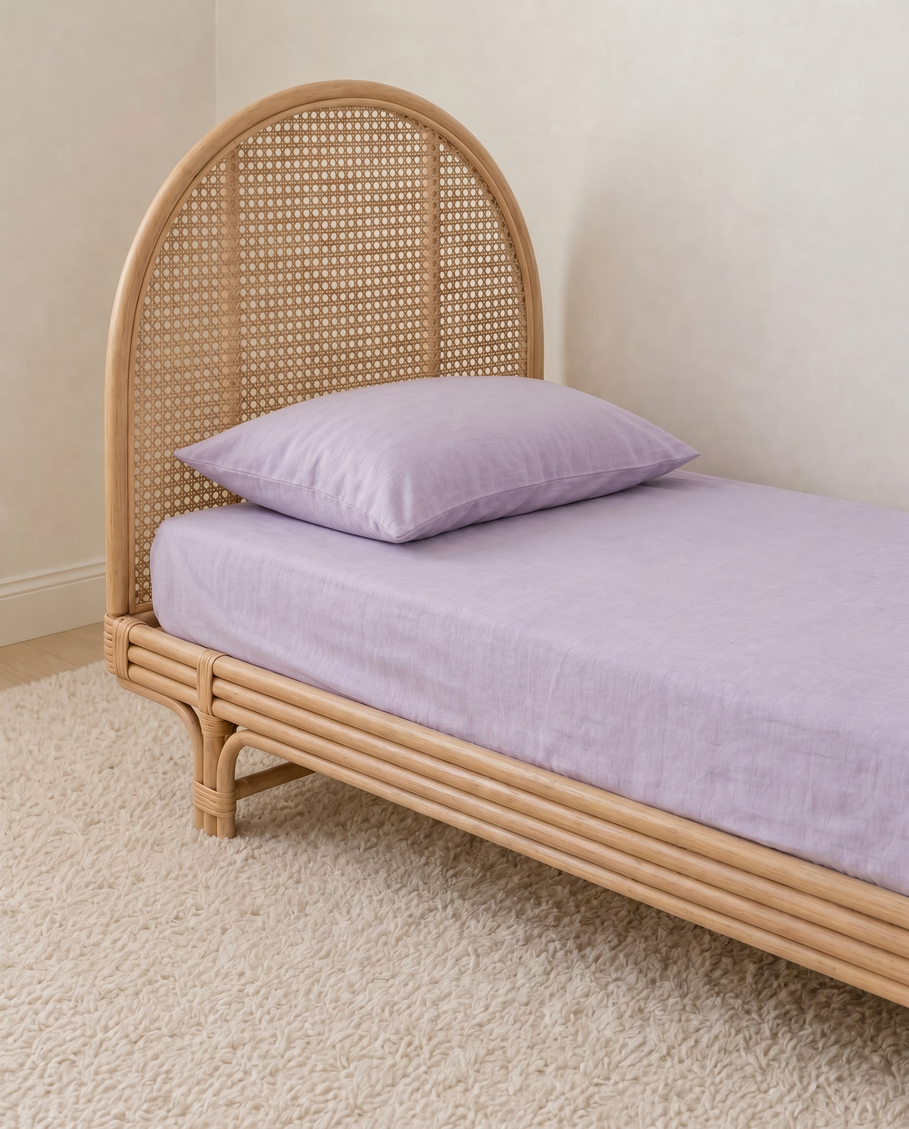 Lavender Organic Cotton Sheet by the cuddle collective styled on a single bed