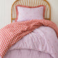 a girly purple heart and red gingham quilt cover made with organic cotton, for the cuddle collective. a beautiful kids bedding set