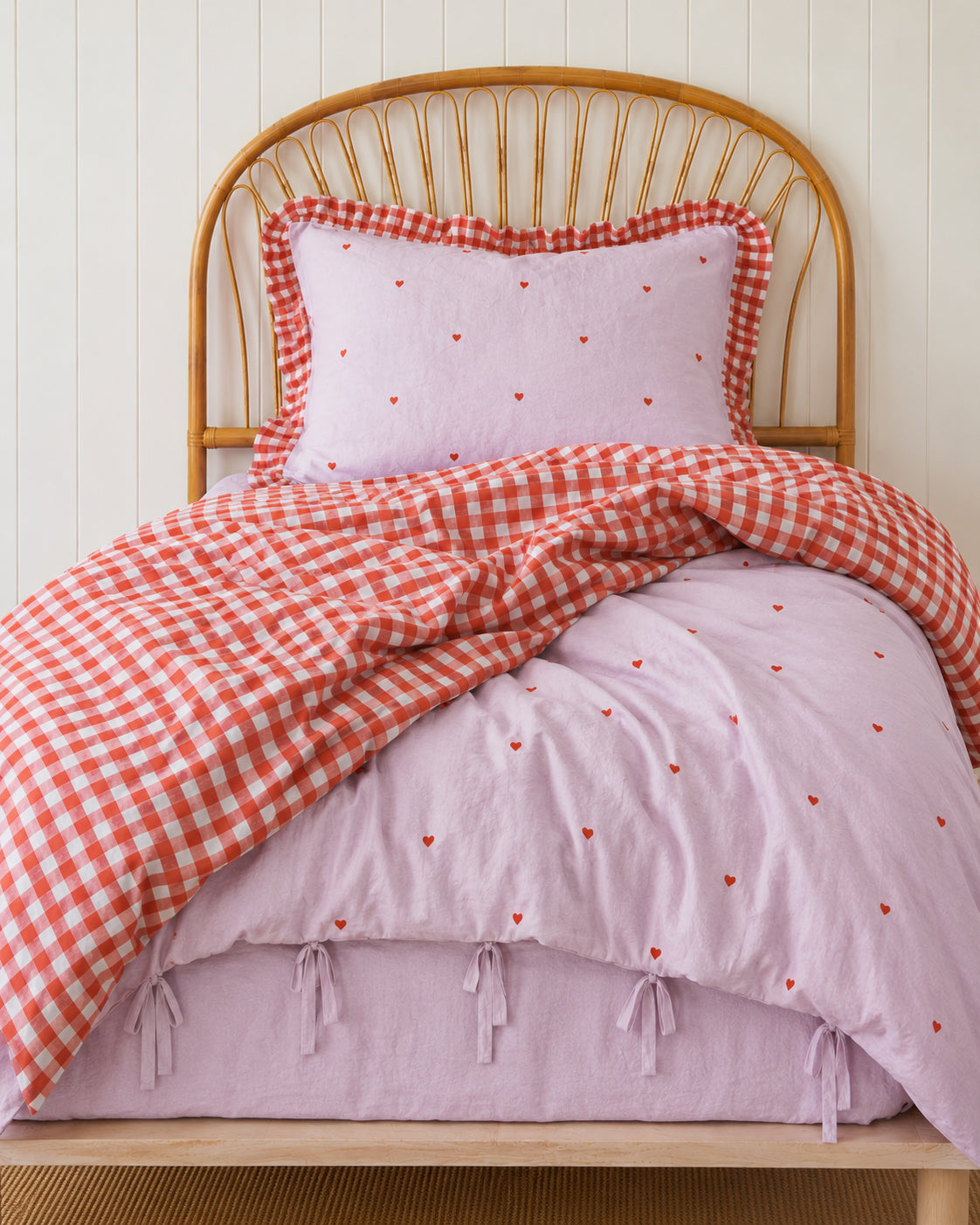 a girly purple heart and red gingham quilt cover made with organic cotton, for the cuddle collective. a beautiful kids bedding set