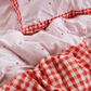 A double sided kids quilt  cover in heart and red gingham print