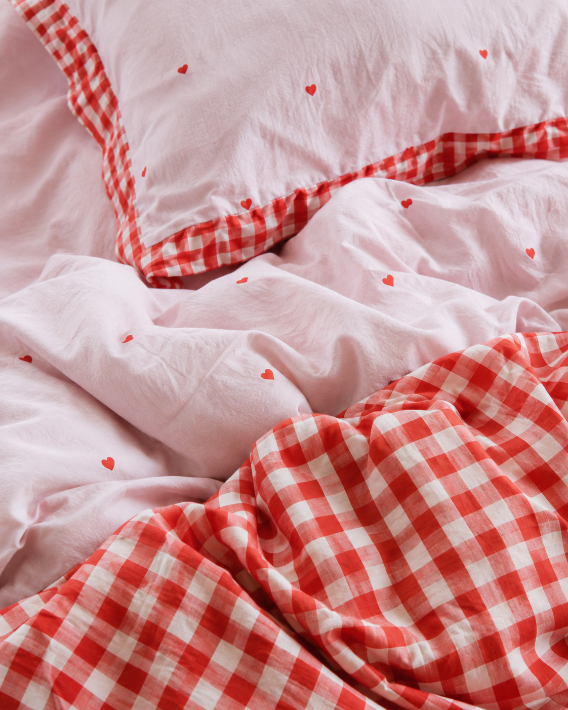 A double sided kids quilt  cover in heart and red gingham print