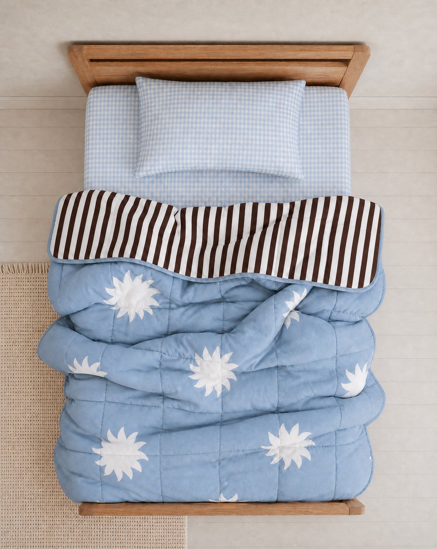 A blue star and chocolate stripe reversible quilt and blue gingham kids organic cotton bedding collection