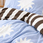 a double sided kids quilt cover in the Blue and Sun sol print in a fun modern kids bedroom