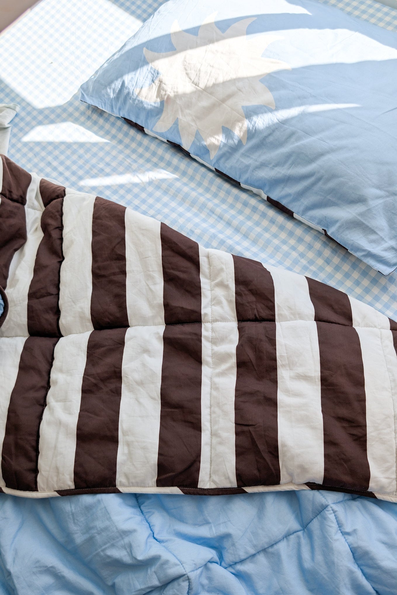 Cornflower blue and brown stripe reversible quilt and organic cotton bedding set