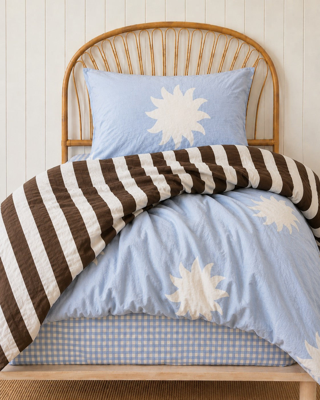 a brown stripe and sun print quilt cover made with organic cotton, for the cuddle collective. a beautiful kids bedding set
