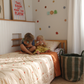 Starfall set featuring a Organic Cotton reversible quilt, stripe sheet set and star wall decals by the cuddle collective Australia.