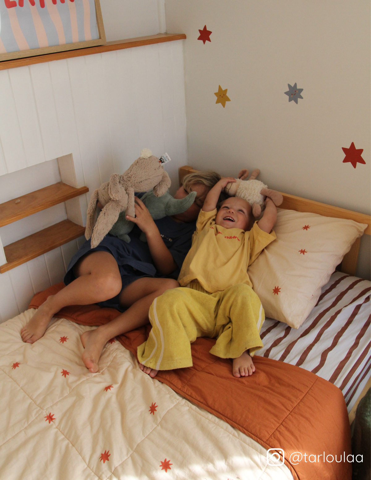 The starfall and coco stripe organic cotton bedding on a kids single bed