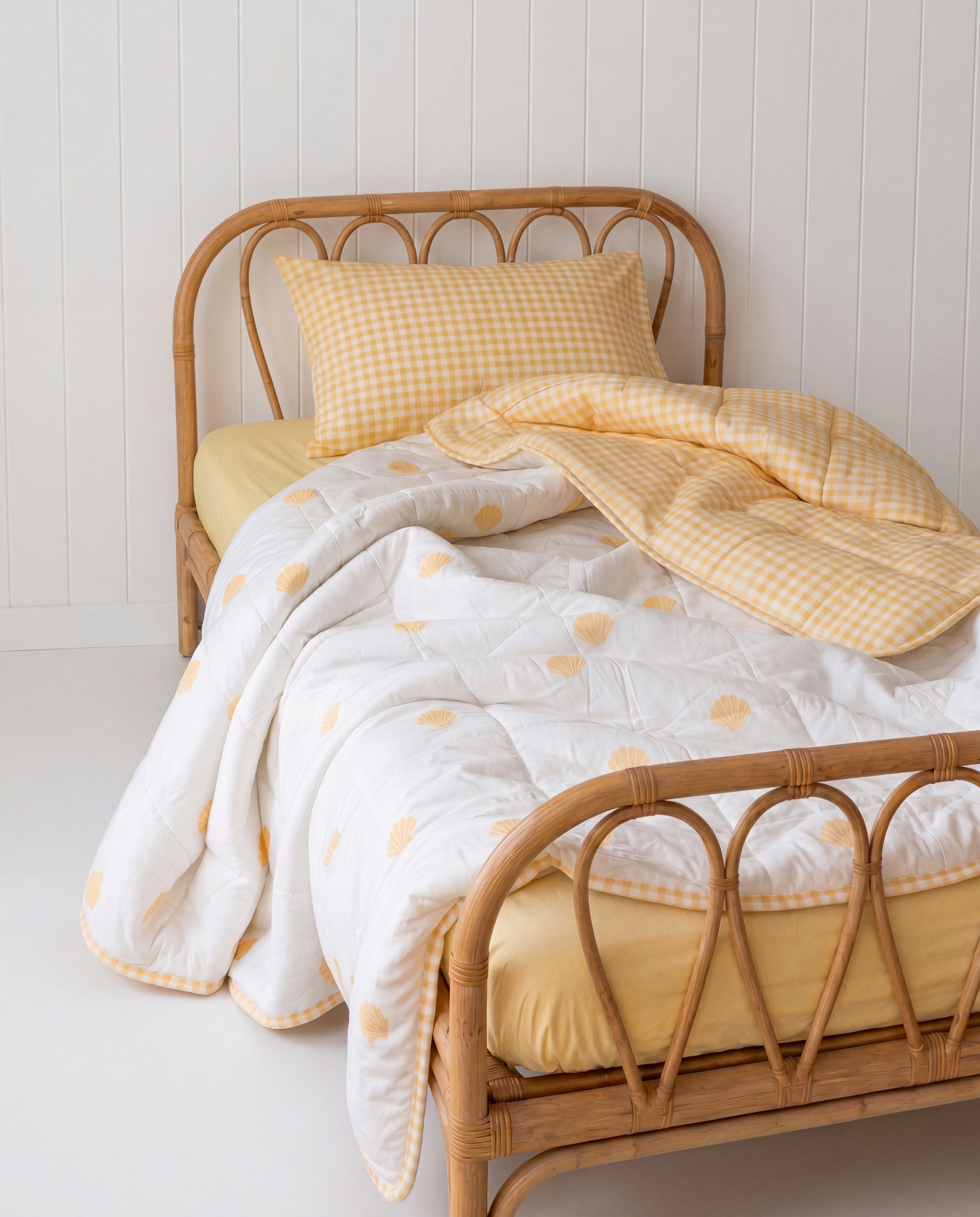 Sunnyside Organic Cotton Double Sided Quilt by the cuddle collective, paired with butter yellow sheet set