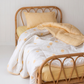 Sunnyside Organic Cotton Double Sided Quilt by the cuddle collective, paired with butter yellow sheet set