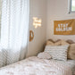 A neutral and coastal kids room featuring kids curtains made of organic cotton completes this cute coastal kids bedding look, an aesthetic kids bedroom, playroom, Montessori room | The Cuddle Collective