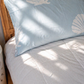 Kids bed styled with Baby Blue Shell organic cotton sheets in soft blue tones