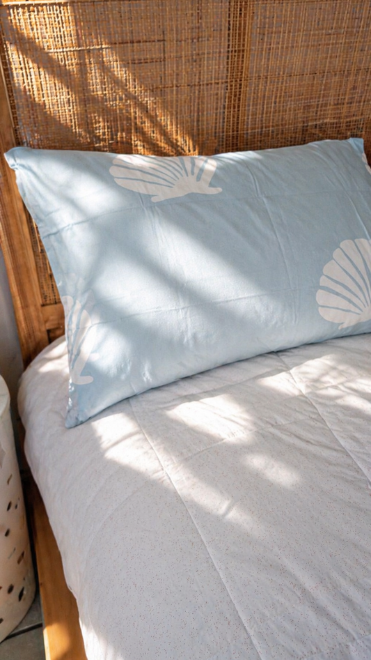 Kids bed styled with Baby Blue Shell organic cotton sheets in soft blue tones