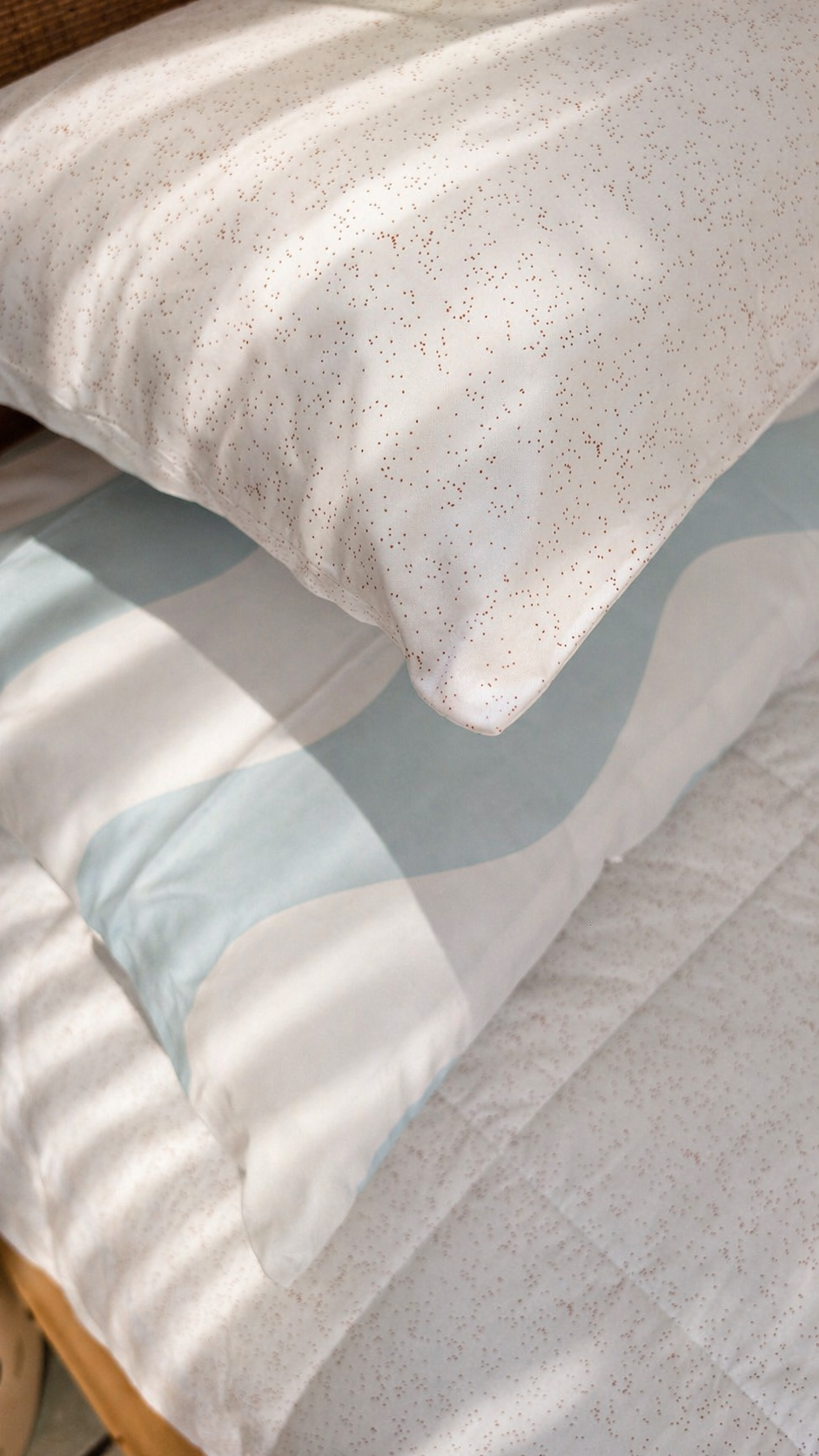 Baby blue waves and speckle pillowcases paired as a kids bedding set