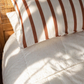 Kids bed styled with Coco Stripe organic cotton sheets in neutral stripe pattern