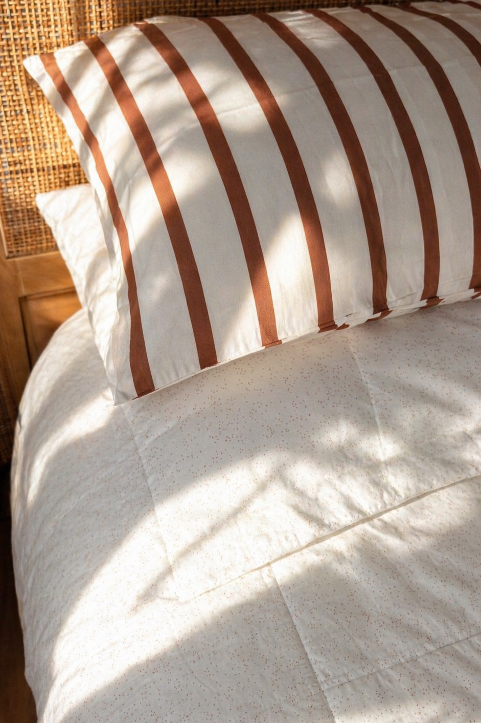 Kids bed styled with Coco Stripe organic cotton sheets in neutral stripe pattern