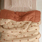 Starfall quilt styled with Coco Stripe organic cotton sheets on a kids bed
