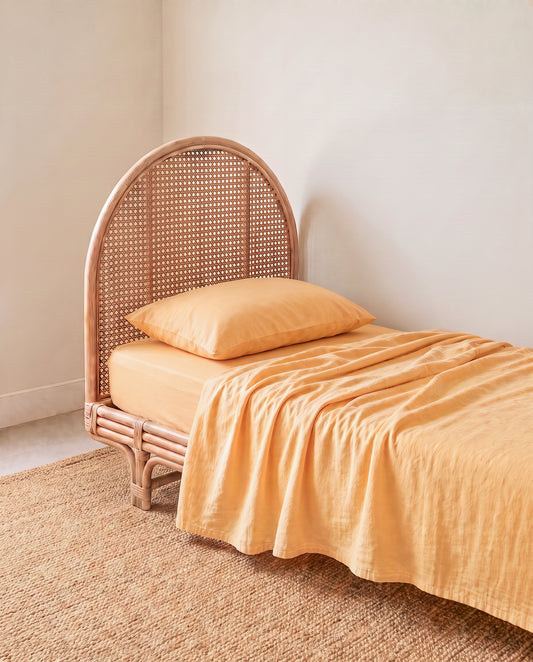 a light yellow orange organic cotton flat sheet by the cuddle collective