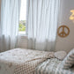 A neutral and coastal kids room featuring kids curtains made of organic cotton completes this cute coastal kids bedding look, an aesthetic kids bedroom, playroom, Montessori room | The Cuddle Collective
