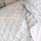 A neutral and coastal kids bed made with organic cotton sheets and organic cotton reversible quilt blanket with wavy stripe print completes this cute coastal kids bedding linen look | The Cuddle Collective