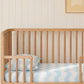 cot sheet on a baby cot in a nursery with blue waves