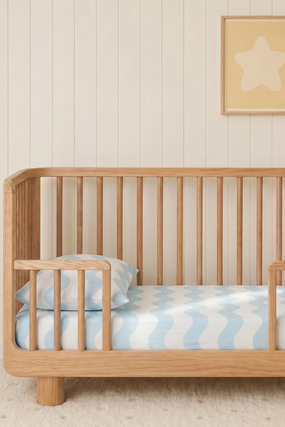 cot sheet on a baby cot in a nursery with blue waves