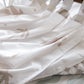 A neutral and coastal kids room featuring kids curtains made of organic cotton completes this cute coastal kids bedding look, an aesthetic kids bedroom, playroom, Montessori room | The Cuddle Collective