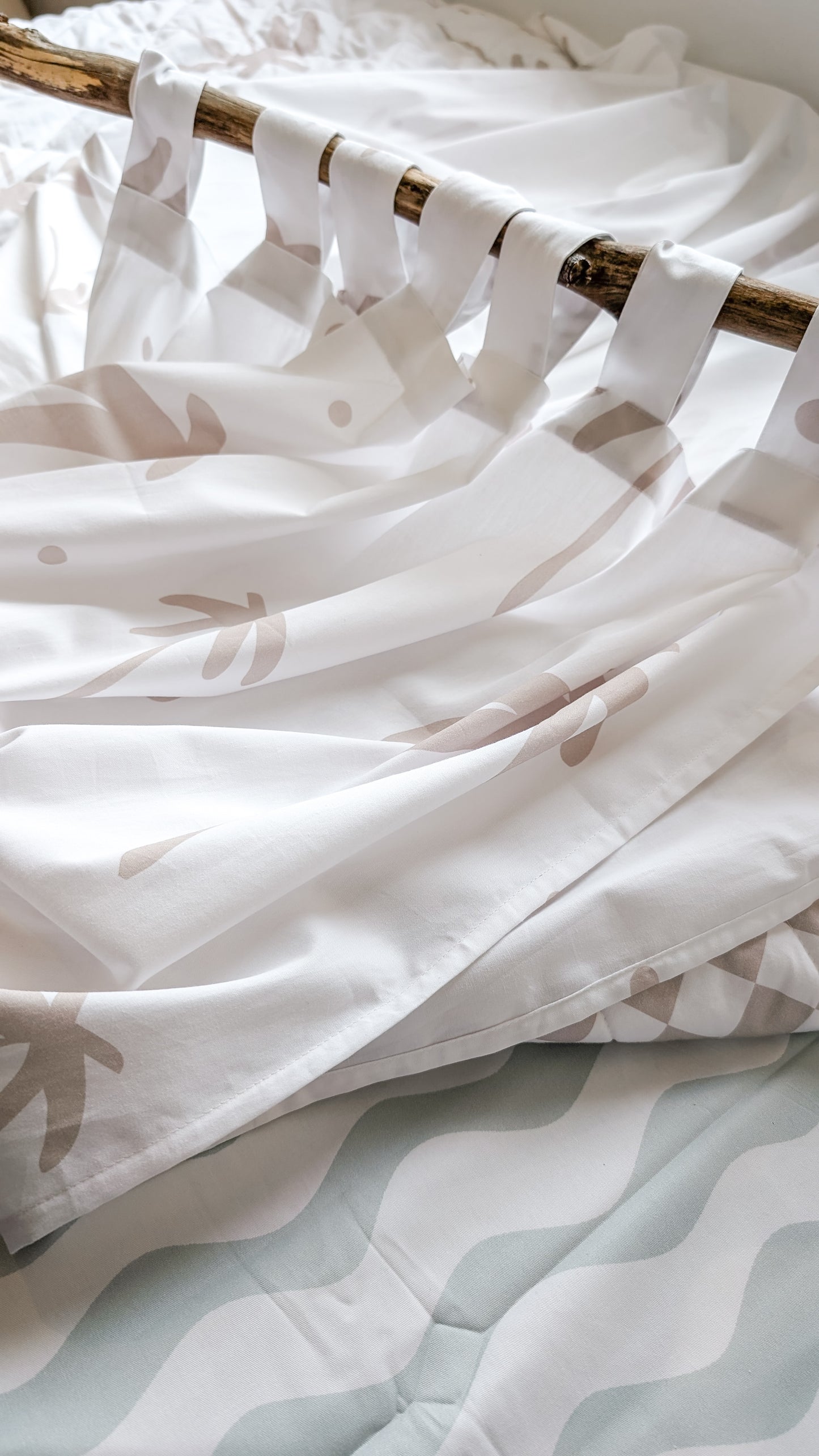 A neutral and coastal kids room featuring kids curtains made of organic cotton completes this cute coastal kids bedding look, an aesthetic kids bedroom, playroom, Montessori room | The Cuddle Collective