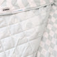 A neutral and coastal kids bed made with organic cotton sheets and organic cotton reversible quilt blanket with wavy stripe print completes this cute coastal kids bedding linen look | The Cuddle Collective